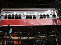 An artisan cleans a model of a tram on a temporary platform ahead of the Durga Puja festival in Kolkata, India, on September 28, 2024. The a...