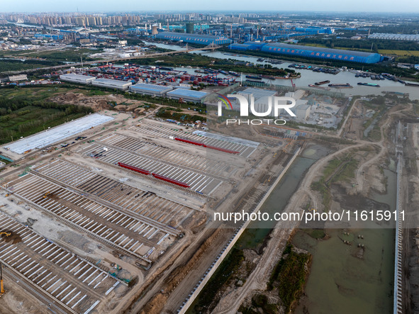 Workers work at the construction site of the third phase of the Canal New Port operation zone in Huai'an, China, on September 28, 2024. 