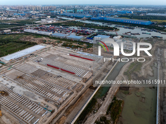 Workers work at the construction site of the third phase of the Canal New Port operation zone in Huai'an, China, on September 28, 2024. (