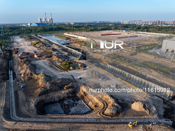 Workers work at the construction site of the third phase of the Canal New Port operation zone in Huai'an, China, on September 28, 2024. 