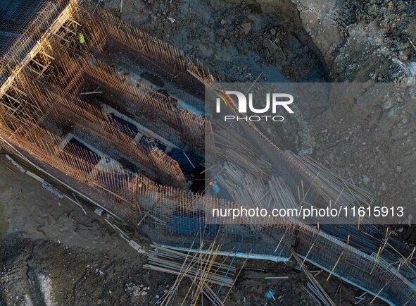 Workers work at the construction site of the third phase of the Canal New Port operation zone in Huai'an, China, on September 28, 2024. 