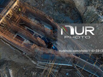 Workers work at the construction site of the third phase of the Canal New Port operation zone in Huai'an, China, on September 28, 2024. (