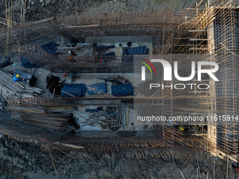 Workers work at the construction site of the third phase of the Canal New Port operation zone in Huai'an, China, on September 28, 2024. (