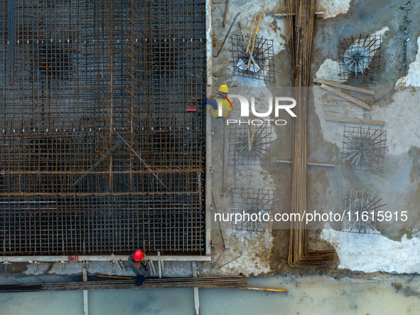 Workers work at the construction site of the third phase of the Canal New Port operation zone in Huai'an, China, on September 28, 2024. 