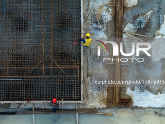 Workers work at the construction site of the third phase of the Canal New Port operation zone in Huai'an, China, on September 28, 2024. (