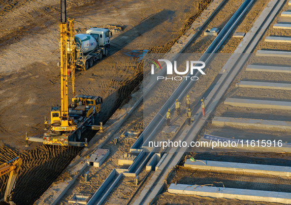 Workers work at the construction site of the third phase of the Canal New Port operation zone in Huai'an, China, on September 28, 2024. 