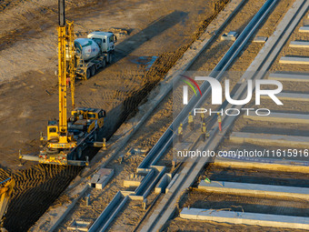 Workers work at the construction site of the third phase of the Canal New Port operation zone in Huai'an, China, on September 28, 2024. (