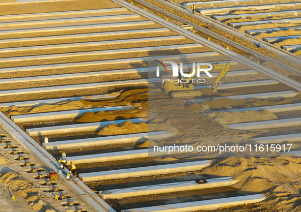 Workers work at the construction site of the third phase of the Canal New Port operation zone in Huai'an, China, on September 28, 2024. 