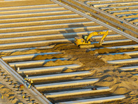 Workers work at the construction site of the third phase of the Canal New Port operation zone in Huai'an, China, on September 28, 2024. (