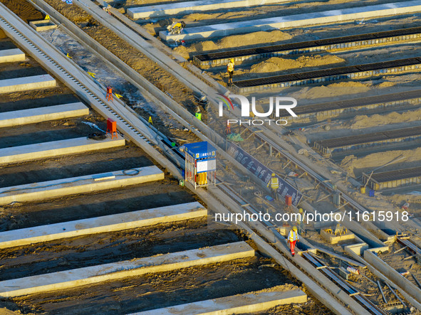 Workers work at the construction site of the third phase of the Canal New Port operation zone in Huai'an, China, on September 28, 2024. 