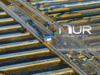 Workers work at the construction site of the third phase of the Canal New Port operation zone in Huai'an, China, on September 28, 2024. (