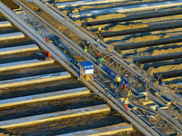 Workers work at the construction site of the third phase of the Canal New Port operation zone in Huai'an, China, on September 28, 2024. (