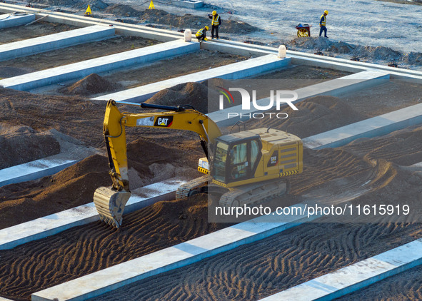 Workers work at the construction site of the third phase of the Canal New Port operation zone in Huai'an, China, on September 28, 2024. 