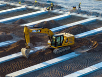 Workers work at the construction site of the third phase of the Canal New Port operation zone in Huai'an, China, on September 28, 2024. (