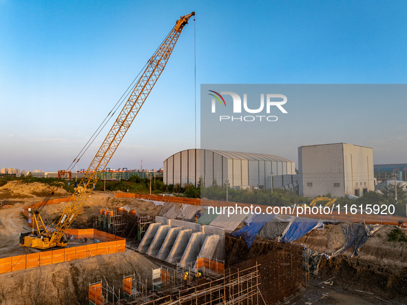 Workers work at the construction site of the third phase of the Canal New Port operation zone in Huai'an, China, on September 28, 2024. 