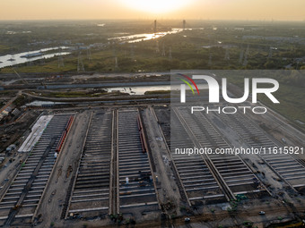 Workers work at the construction site of the third phase of the Canal New Port operation zone in Huai'an, China, on September 28, 2024. (