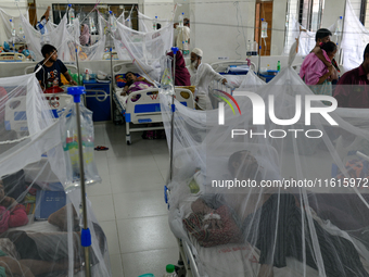 Patients receive medical treatment as they suffer from dengue at a hospital in Dhaka, Bangladesh, on September 28, 2024. (