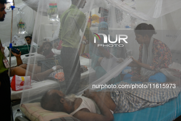 Patients receive medical treatment as they suffer from dengue at a hospital in Dhaka, Bangladesh, on September 28, 2024. 