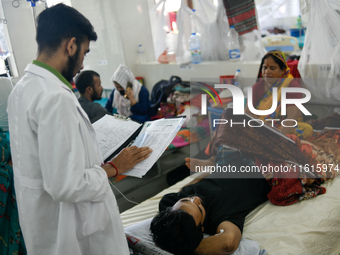 Patients receive medical treatment as they suffer from dengue at a hospital in Dhaka, Bangladesh, on September 28, 2024. (