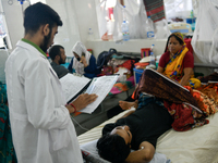 Patients receive medical treatment as they suffer from dengue at a hospital in Dhaka, Bangladesh, on September 28, 2024. (