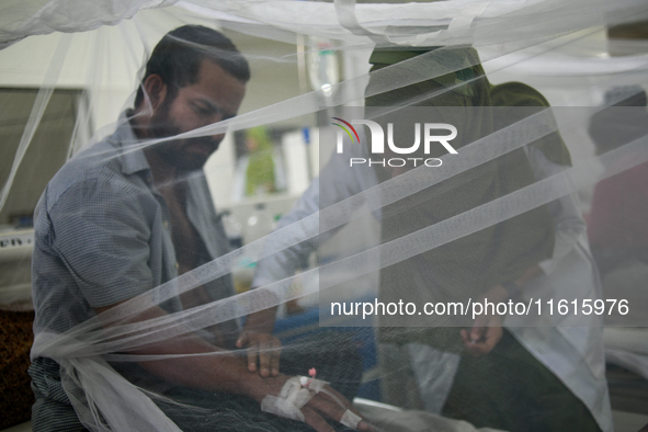 Patients receive medical treatment as they suffer from dengue at a hospital in Dhaka, Bangladesh, on September 28, 2024. 