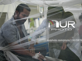 Patients receive medical treatment as they suffer from dengue at a hospital in Dhaka, Bangladesh, on September 28, 2024. (