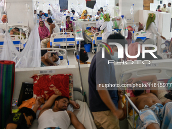 Patients receive medical treatment as they suffer from dengue at a hospital in Dhaka, Bangladesh, on September 28, 2024. (