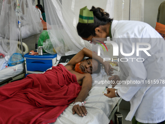 Patients receive medical treatment as they suffer from dengue at a hospital in Dhaka, Bangladesh, on September 28, 2024. (