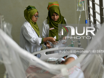 Patients receive medical treatment as they suffer from dengue at a hospital in Dhaka, Bangladesh, on September 28, 2024. (