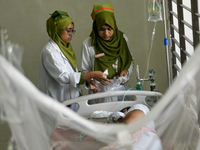 Patients receive medical treatment as they suffer from dengue at a hospital in Dhaka, Bangladesh, on September 28, 2024. (