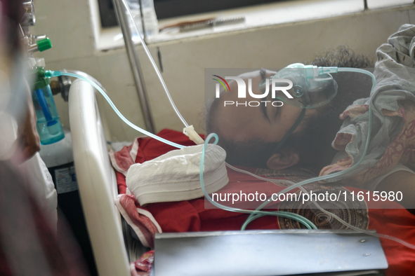 Patients receive medical treatment as they suffer from dengue at a hospital in Dhaka, Bangladesh, on September 28, 2024. 