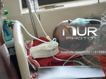 Patients receive medical treatment as they suffer from dengue at a hospital in Dhaka, Bangladesh, on September 28, 2024. (