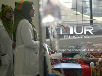 Patients receive medical treatment as they suffer from dengue at a hospital in Dhaka, Bangladesh, on September 28, 2024. (