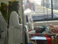 Patients receive medical treatment as they suffer from dengue at a hospital in Dhaka, Bangladesh, on September 28, 2024. (