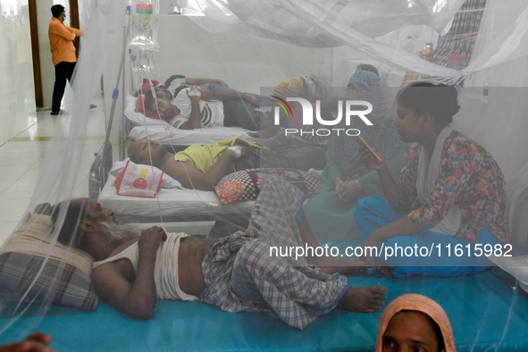 Patients receive medical treatment as they suffer from dengue at a hospital in Dhaka, Bangladesh, on September 28, 2024. 