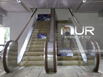 An artisan works inside a model of Howrah Maidan metro station escalators in a ''pandal'' or a temporary platform ahead of the Durga Puja fe...