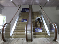 An artisan works inside a model of Howrah Maidan metro station escalators in a ''pandal'' or a temporary platform ahead of the Durga Puja fe...