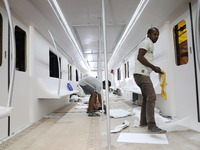 Artisans work inside a model of a metro compartment in a ''pandal'' or a temporary platform ahead of the Durga Puja festival in India on Sep...