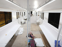 Artisans work inside a model of a metro compartment in a ''pandal'' or a temporary platform ahead of the Durga Puja festival in India on Sep...