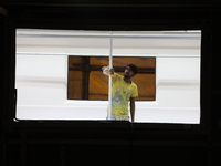 An artisan works inside a model of a metro compartment in a ''pandal'' or temporary platform ahead of the Durga Puja festival in India on Se...