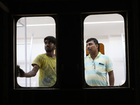 Artisans work inside a model of a metro compartment in a ''pandal'' or a temporary platform ahead of the Durga Puja festival in India on Sep...