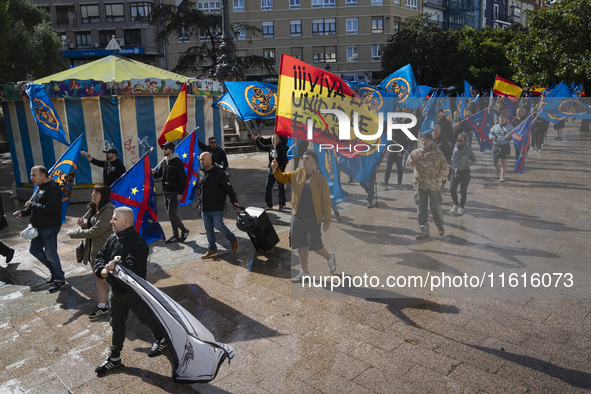 A young man holds a Spanish flag reading ''Long live the unity of Spain'' during a demonstration organized by the Alfonso I Association unde...