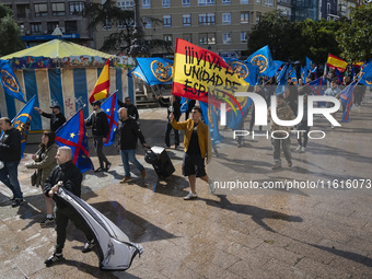 A young man holds a Spanish flag reading ''Long live the unity of Spain'' during a demonstration organized by the Alfonso I Association unde...