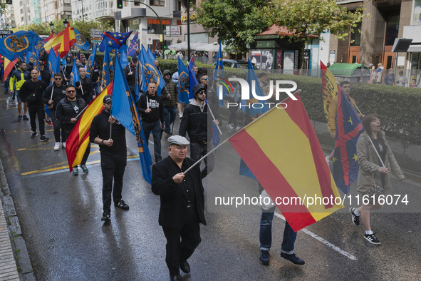 Flags of Spain mix with blue flags with the logo of the Alfonso I Association during the demonstration organized by the Association under th...