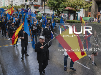 Flags of Spain mix with blue flags with the logo of the Alfonso I Association during the demonstration organized by the Association under th...