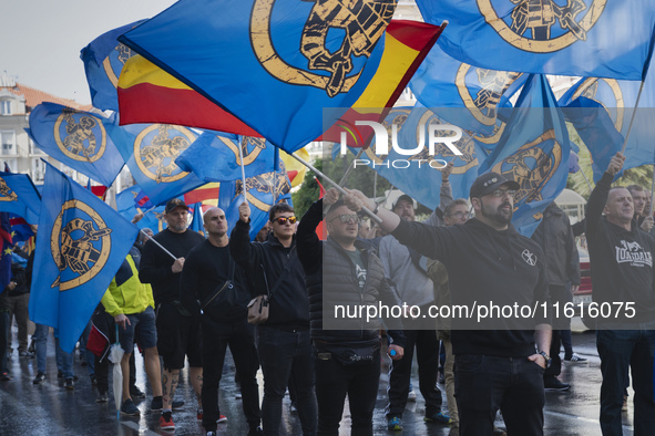 Flags of Spain mix with blue flags with the logo of the Alfonso I Association during the demonstration organized by the Association under th...