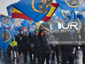 Flags of Spain mix with blue flags with the logo of the Alfonso I Association during the demonstration organized by the Association under th...