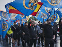 Flags of Spain mix with blue flags with the logo of the Alfonso I Association during the demonstration organized by the Association under th...