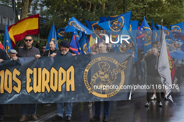 Flags of Spain mix with blue flags with the logo of the Alfonso I Association during the demonstration organized by the Association under th...