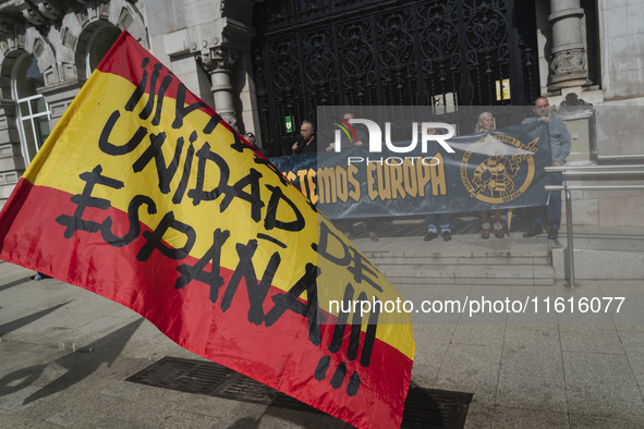 A Spanish flag with the words ''Long live the unity of Spain'' is waved by a supporter during the reading of the manifesto at the demonstrat...